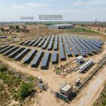 Ground-mounted solar panels installed on open land in Pakistan showing panel tilt, spacing, and metal mounting structures