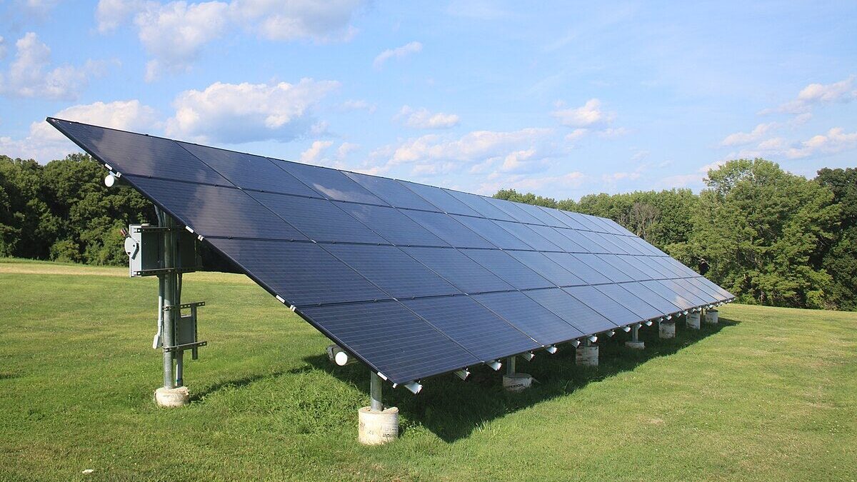 Ground-mounted solar panels installed on open land in Pakistan showing panel tilt, spacing, and metal mounting structures