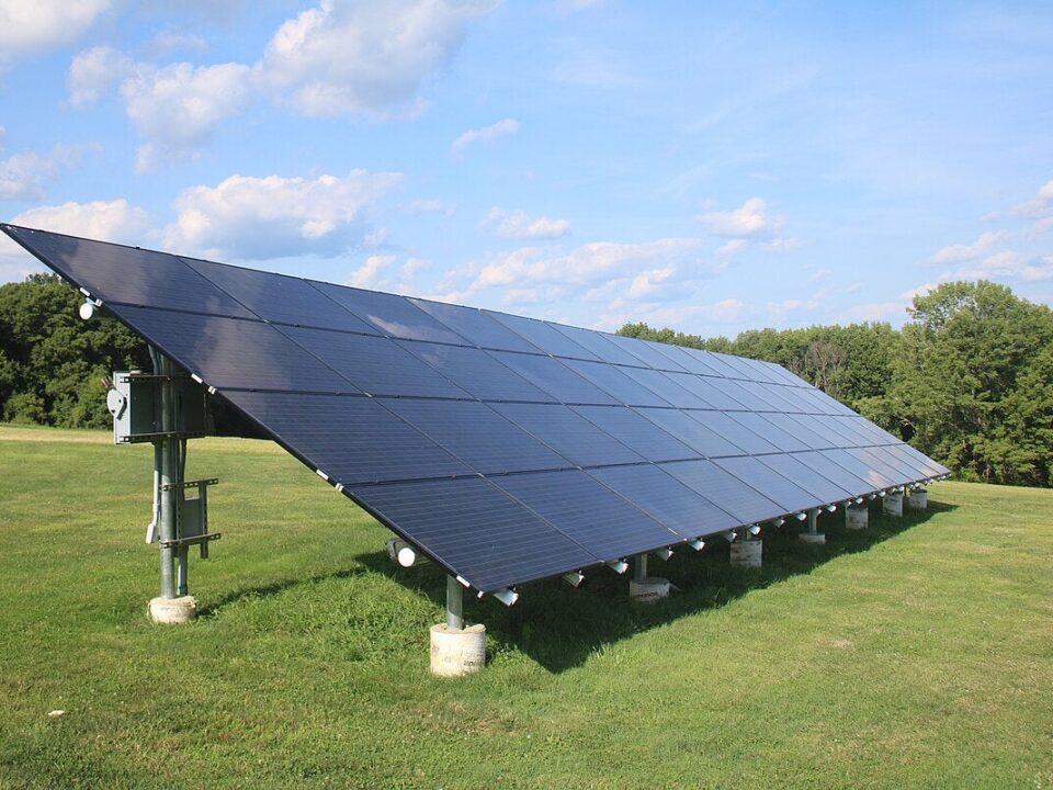 Ground-mounted solar panels installed on open land in Pakistan showing panel tilt, spacing, and metal mounting structures